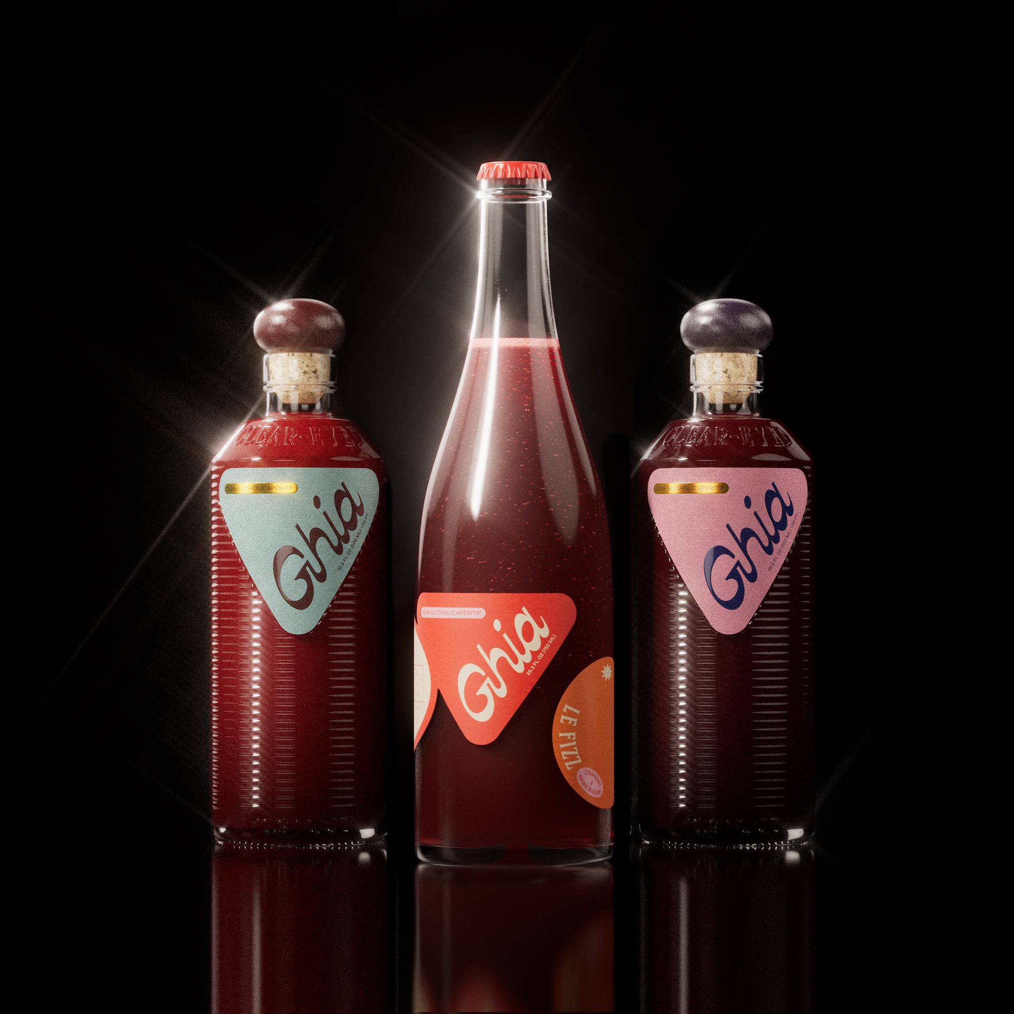 Ghia Bottle Bundle featuring a 750ml bottle of Le Fizz and two 500ml bottles of the Apéritif in Original and Berry flavors, arranged on a reflective white background. A non-alcoholic beverage set designed for mindful drinking.