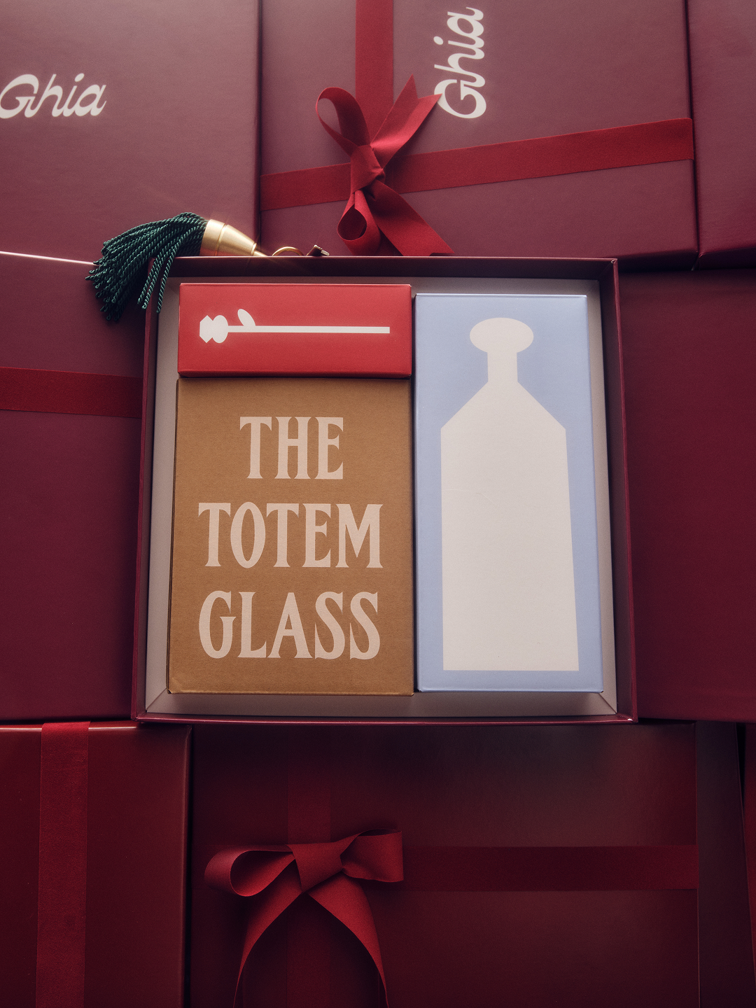 The Totem Glass box nestled inside a red Ghia gift box with ribbon