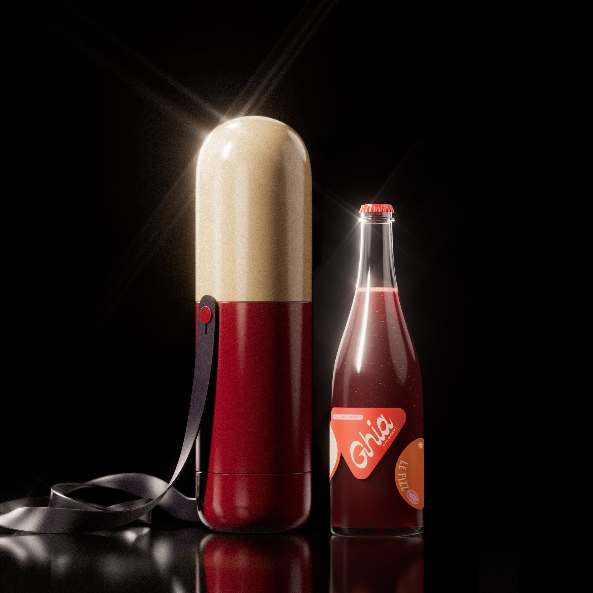Cream and red pill-shaped Ghia carrier with strap beside a bottle of Ghia Le Fizz on a black background