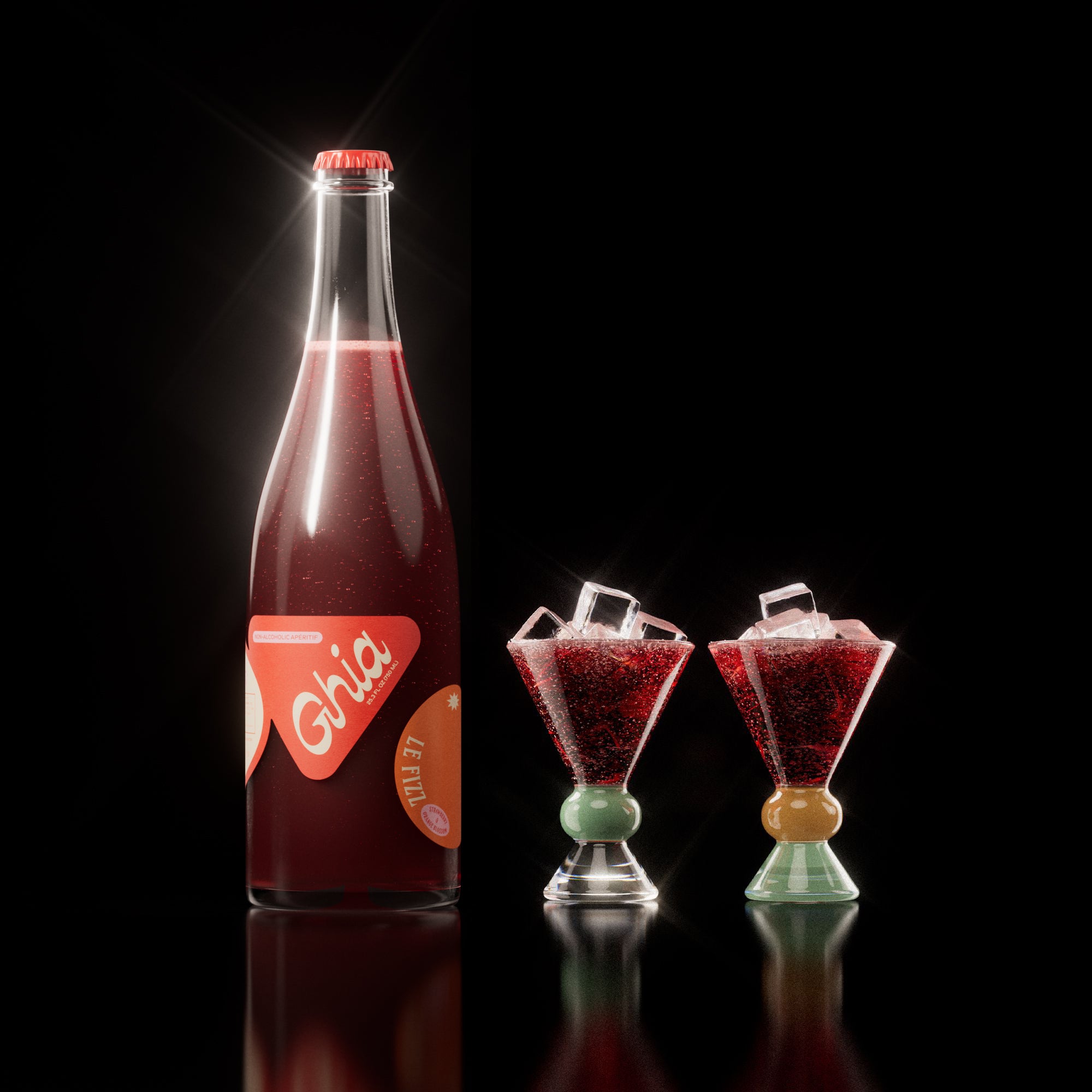 Non-alcoholic spritz in a bottle filled with a deep red strawberry and orange blossom beverage, featuring red labels. Alongside decorative cocktail glass that has a clear, jade and sand base.
